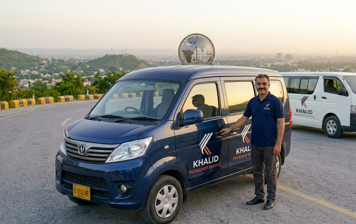 A professional driver in a uniform shirt standing beside a deep blue Changan minivan with 'KHALID PICK&DROP SERVICE' on a winding road